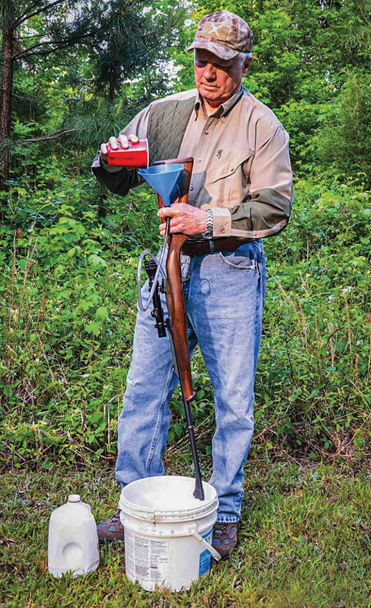 When developing a load for a rifle, Layne prefers to cool its barrel between each group fired by running water through its bore. His homemade cooler was made by gluing one end of a plastic tube small enough to enter the chamber of a barrel to a small funnel. Water is brought to the range in one-gallon plastic jugs and a cup is used to pour it through the bore slowly to prevent backflow.